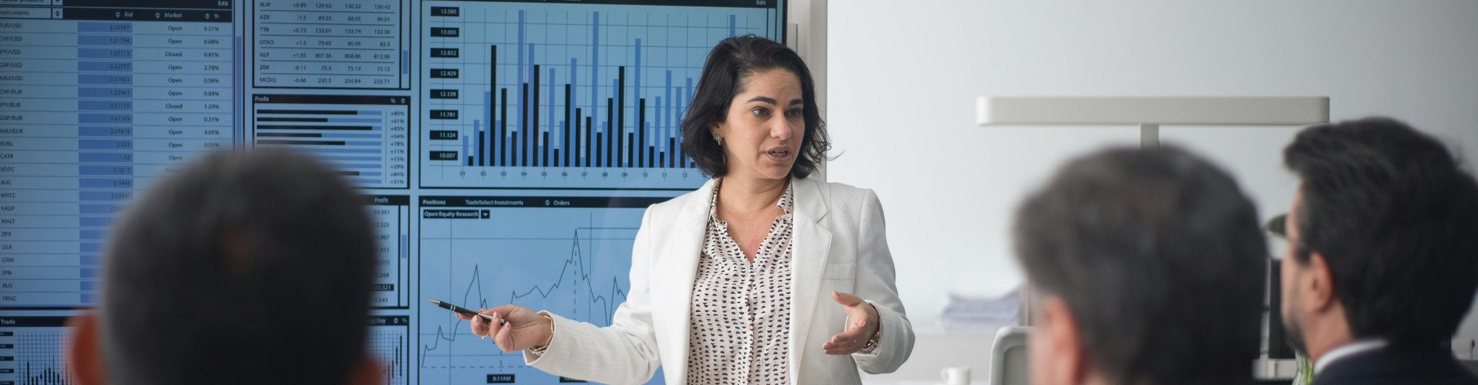 Woman presenting technical charts in a white room