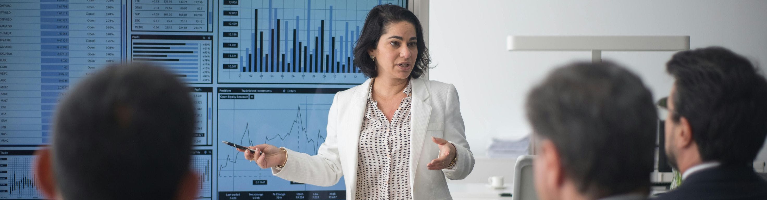 Woman presenting technical charts in a white room