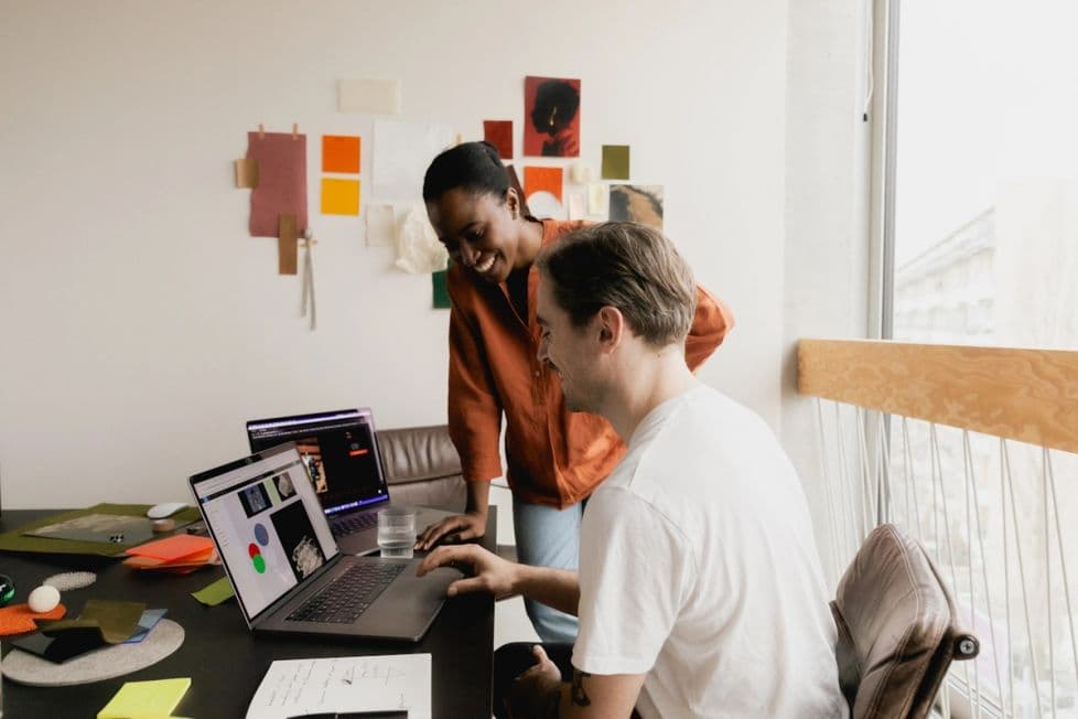 Two people collaborating on design in a bright office