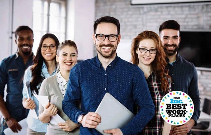 6 people standing in a V formation holding folders and paper with the 2020 Inc. Best Work-Places logo