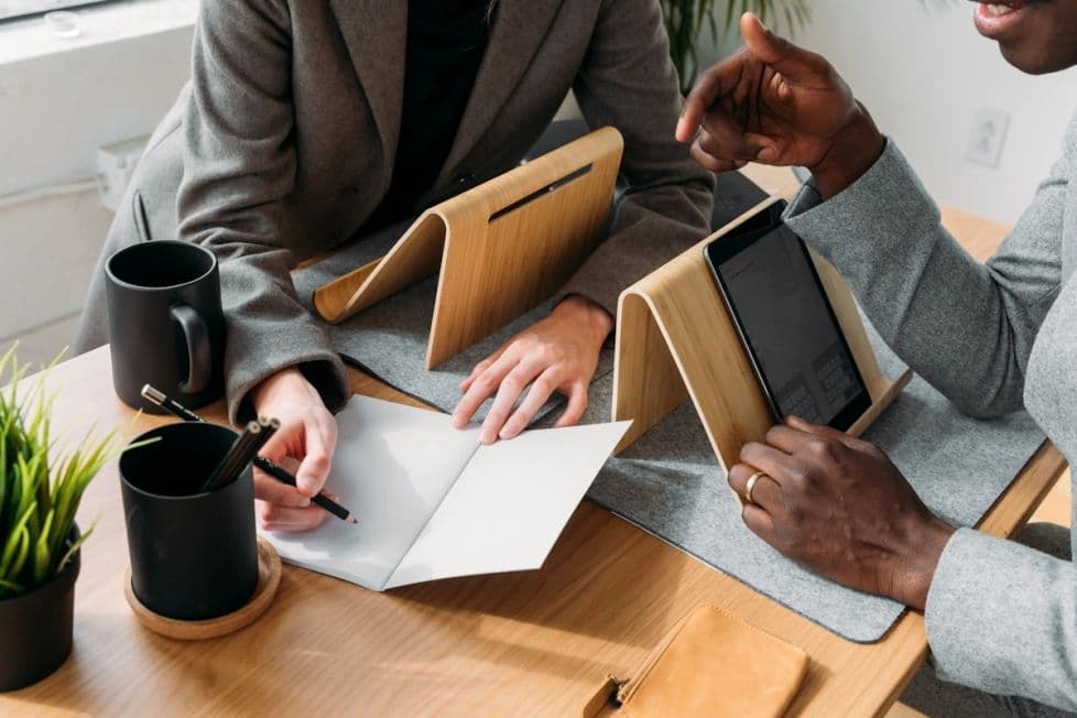 Close up of tablets hands and notebook