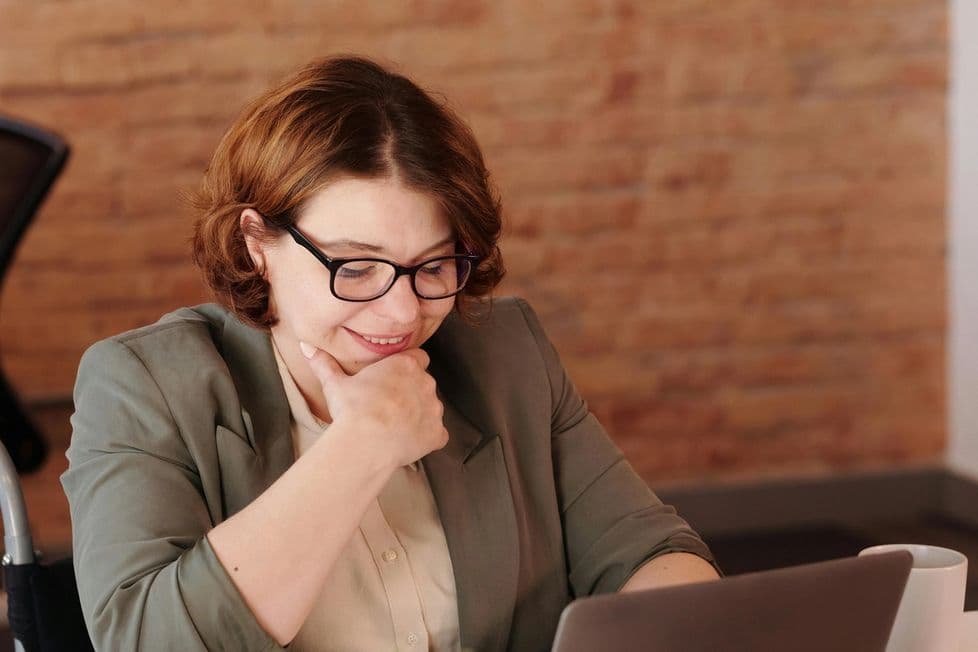 Woman smiling while working at her computer