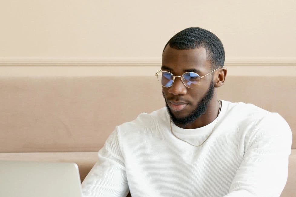 Man in bright modern office working at laptop