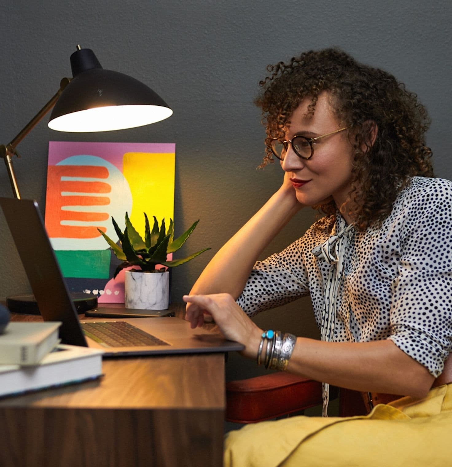 Woman in yellow skirt working in a cozy design office