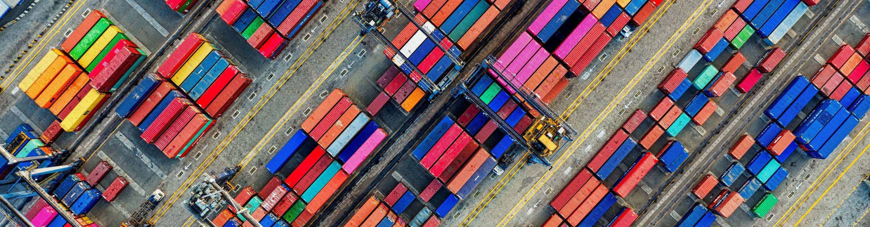 Aerial drone shot of organized shipping containers at a diagonal