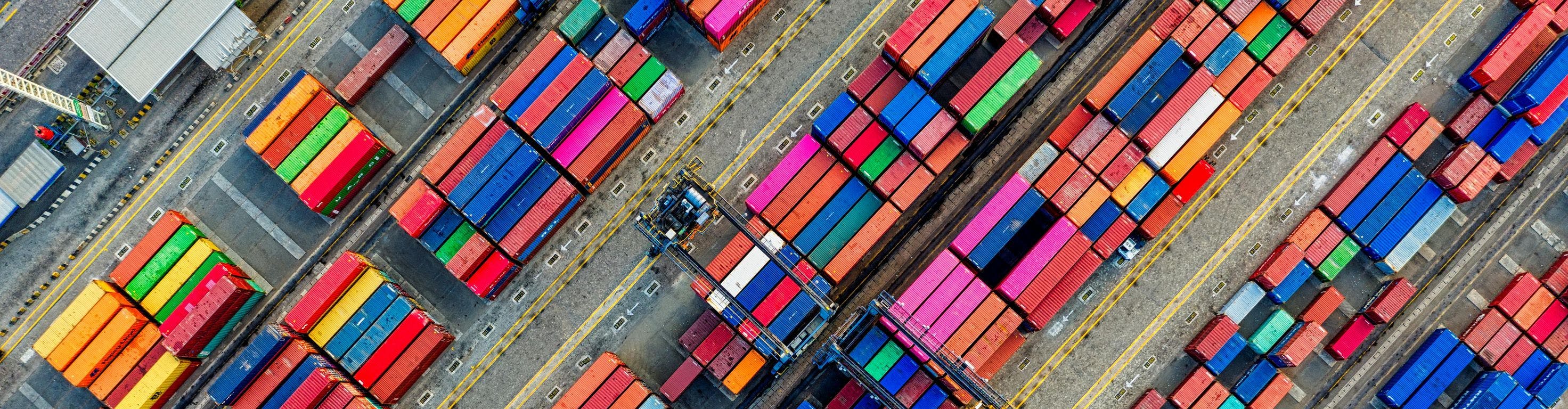 Aerial drone shot of organized shipping containers at a diagonal