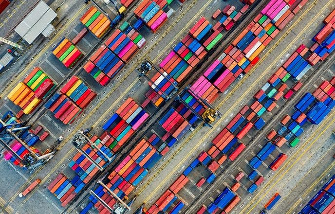 Aerial drone shot of organized shipping containers at a diagonal
