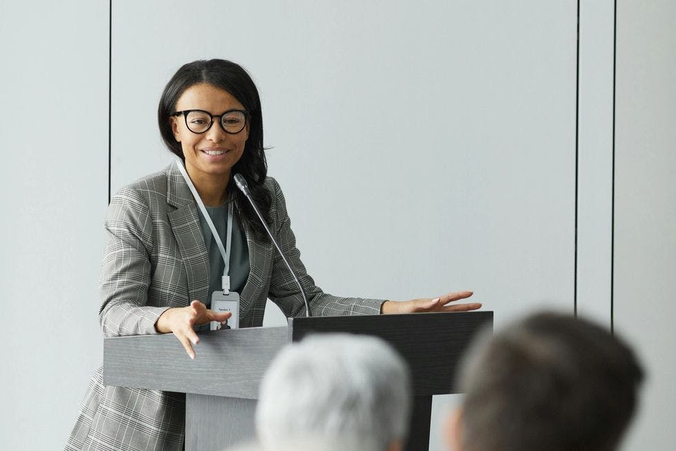 Woman giving a presentation in a white room