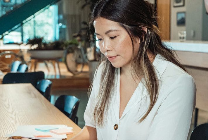 Woman in white blouse working in a warm office